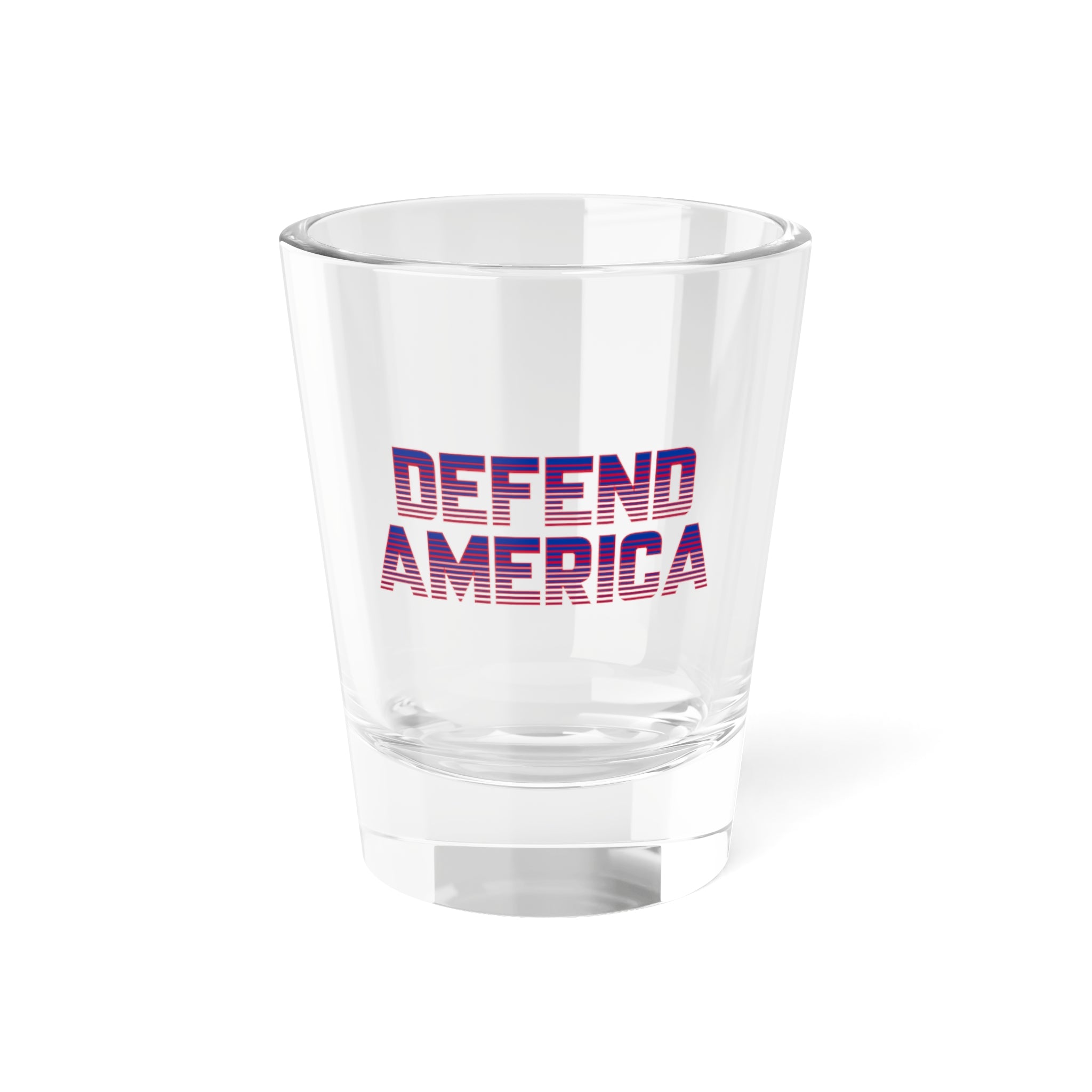 A clear shot glass with 'DEFEND AMERICA' text printed in red and purple on the front.