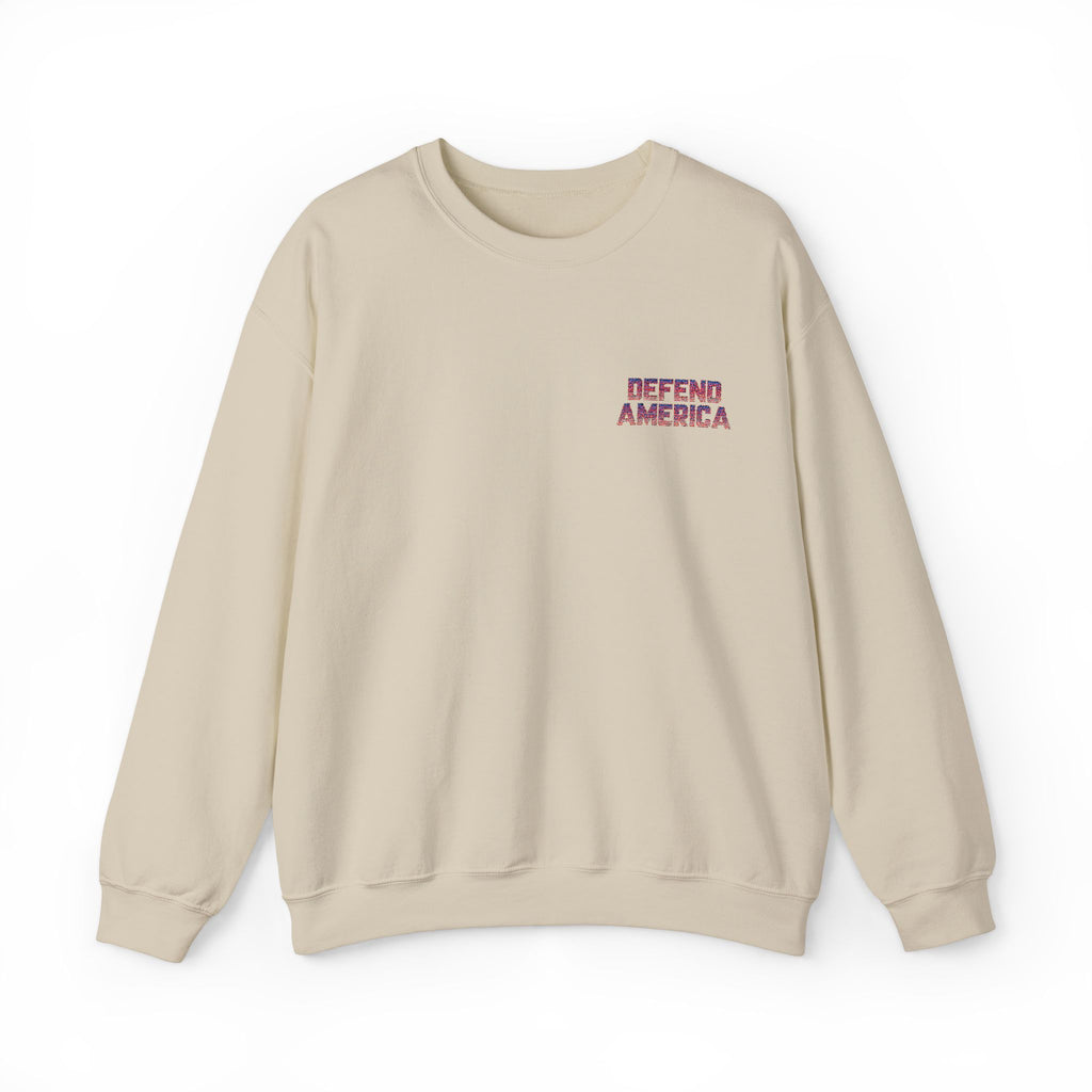 tan sand crewneck sweatshirt with 'DEFEND AMERICA EMBROIDERED CREWNECK SWEATSHIRT' text in red on the chest.