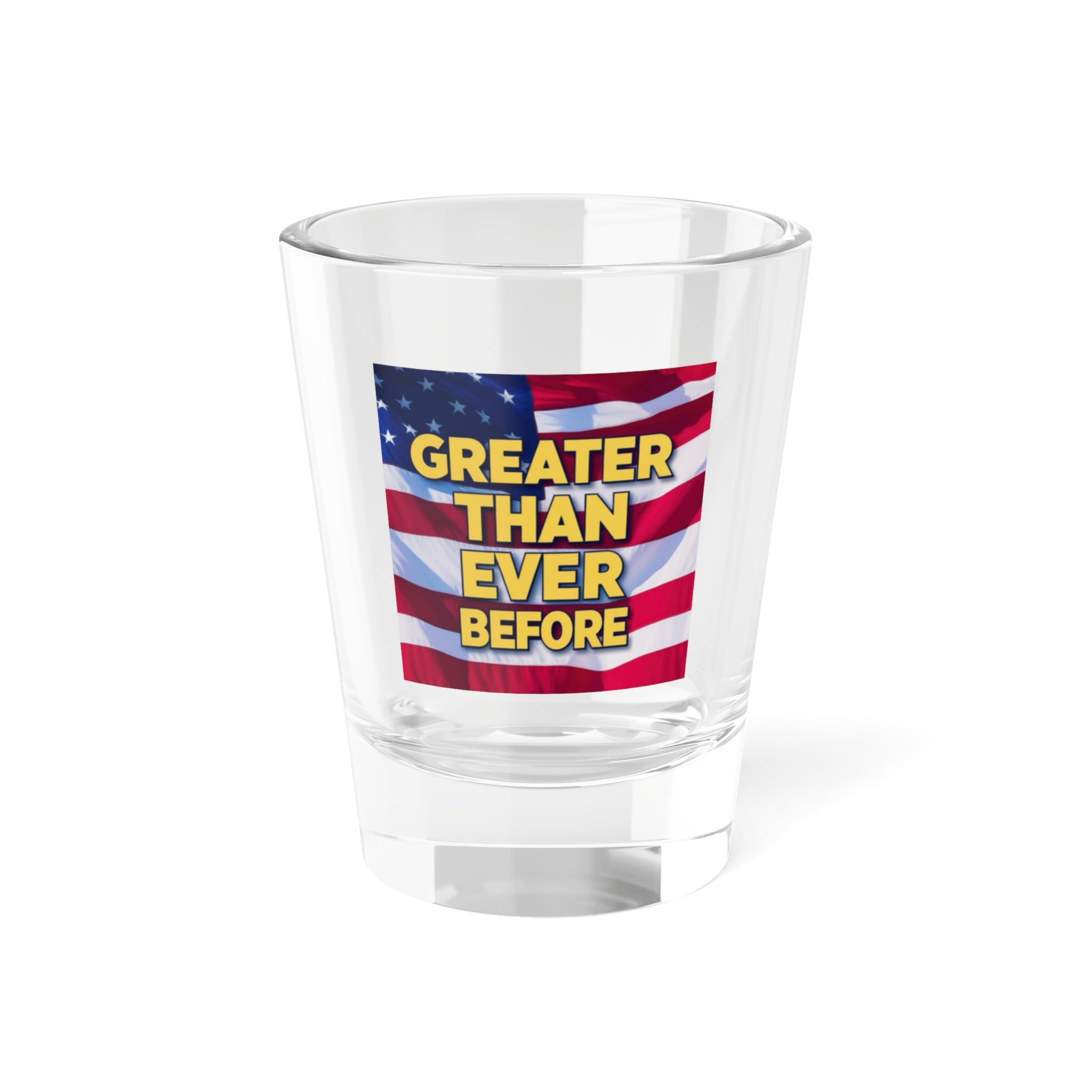 A clear shot glass with a printed American flag and the text 'GREATER THAN EVER BEFORE' on it.
