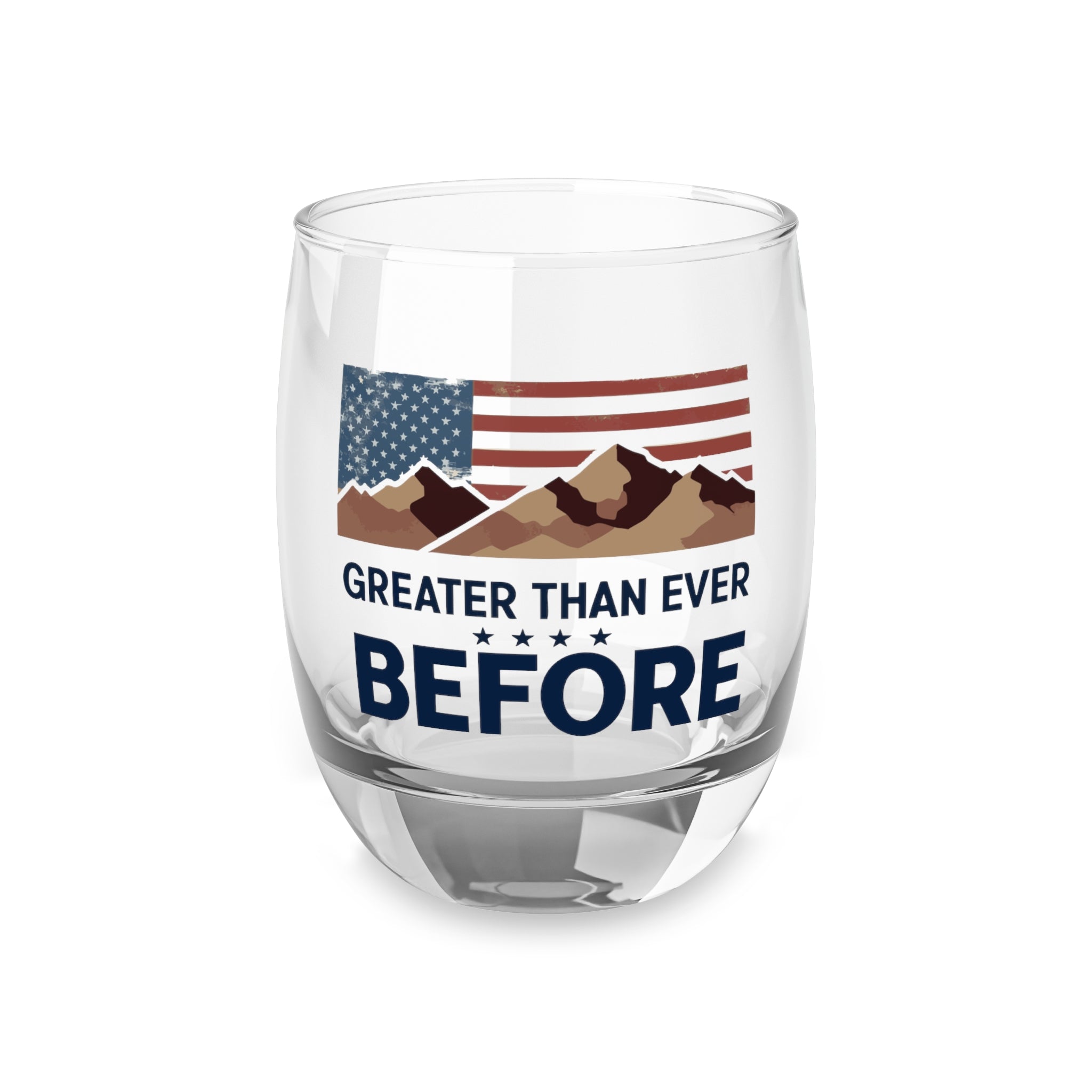 A clear whiskey glass with a print of the American flag and mountain range, and the text 'GREATER THAN EVER BEFORE' on it.