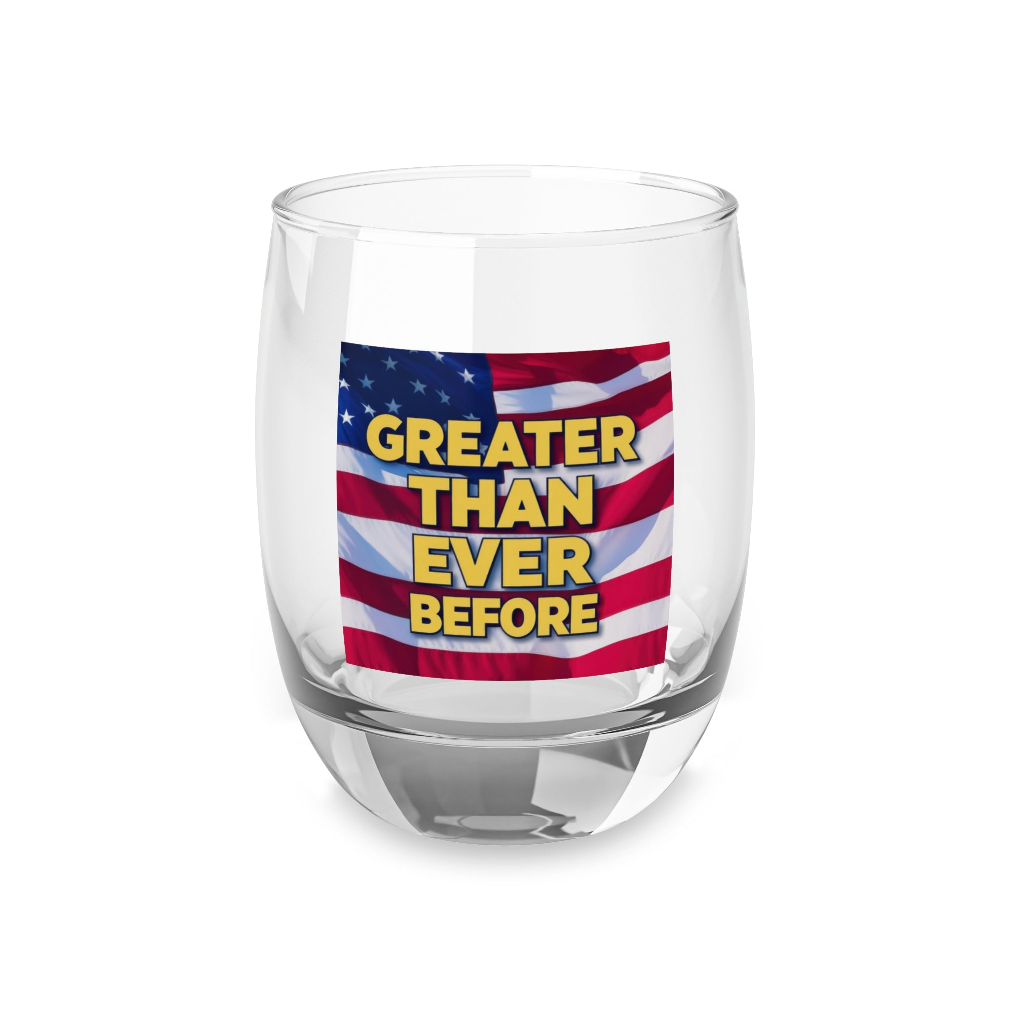 A clear whiskey glass with a vibrant print of the American flag and the text 'GREATER THAN EVER BEFORE' on it.