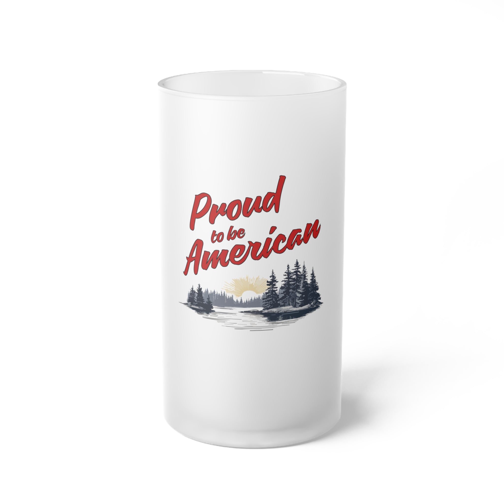 A frosted glass beer mug with 'Proud to be American' text and a patriotic red, white, and blue design, featuring trees and a sunset.