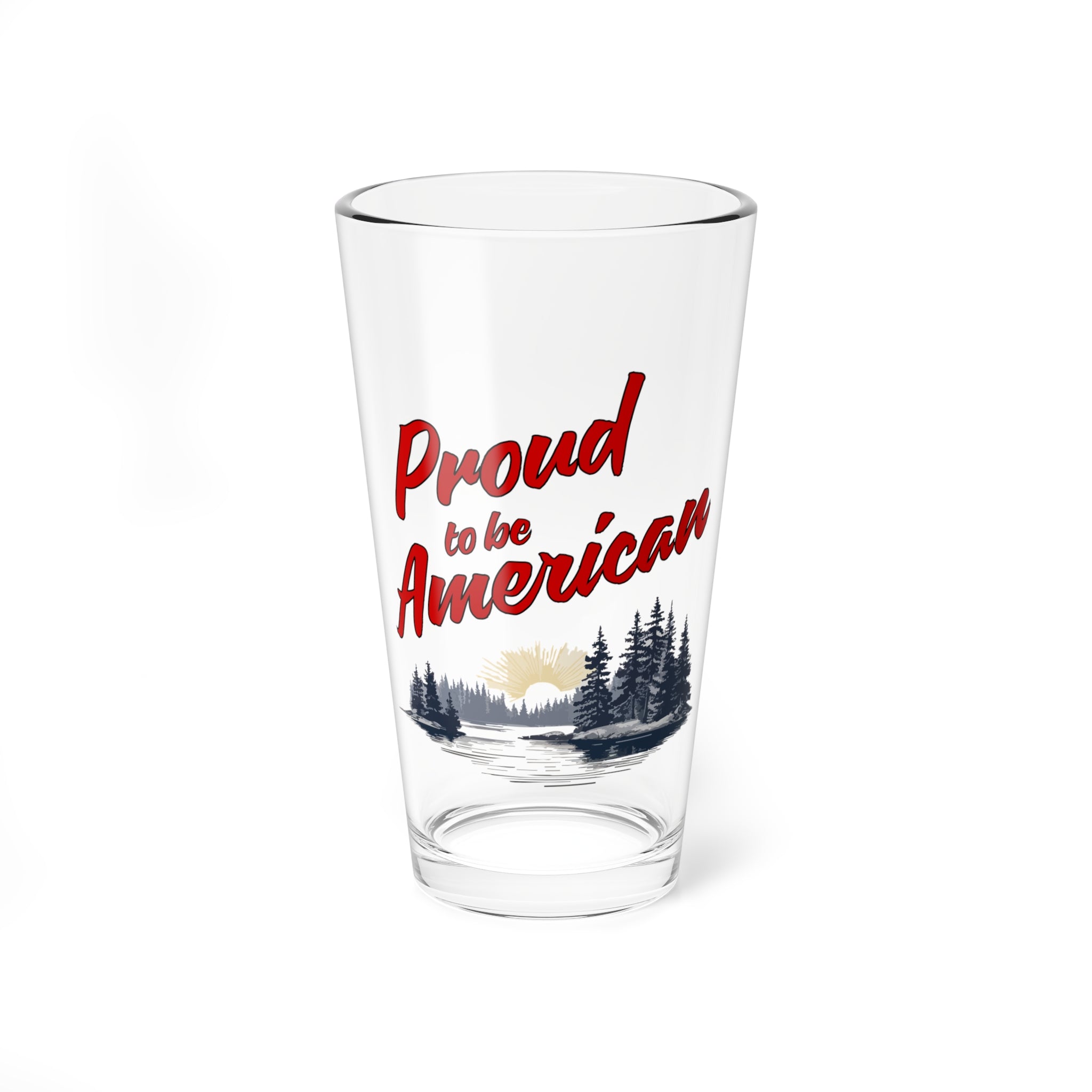 A clear mixing glass with a 'Proud to be American' print and a scenic background.