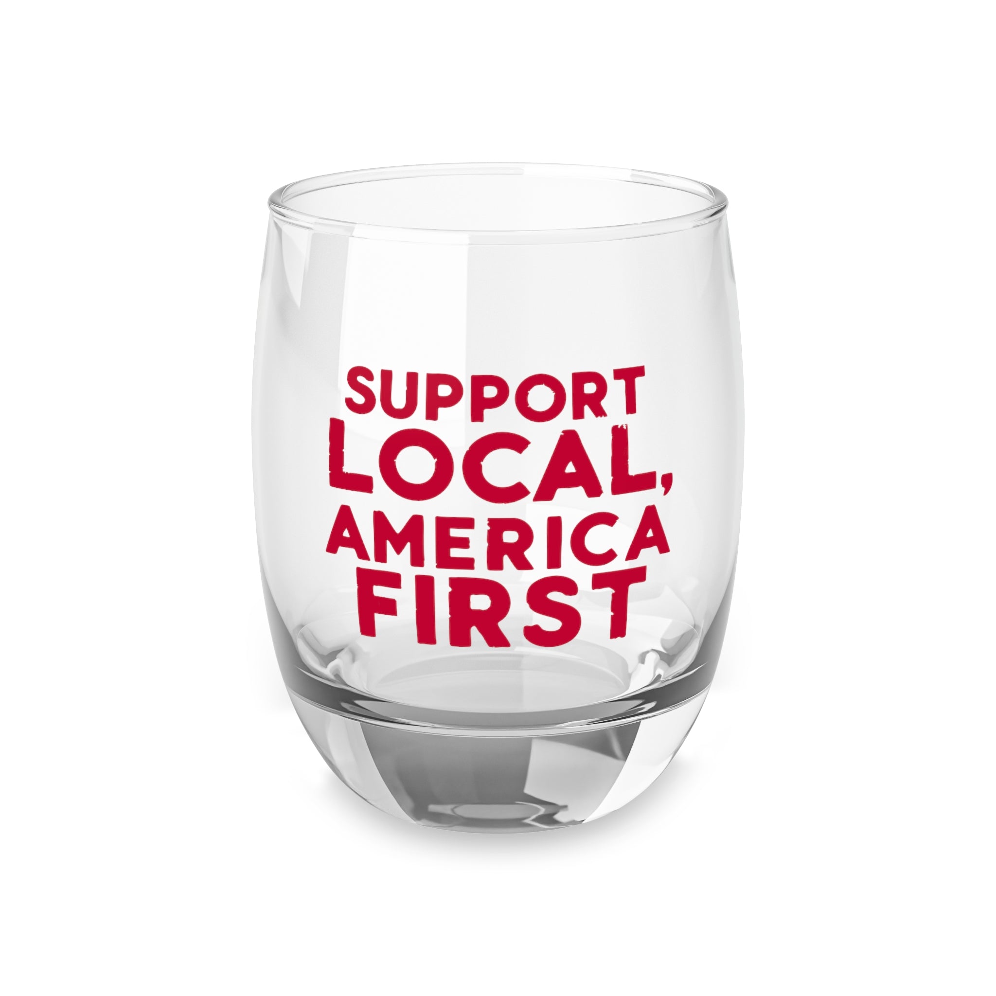 A clear whiskey glass with a red print that reads 'SUPPORT LOCAL, AMERICA FIRST'.