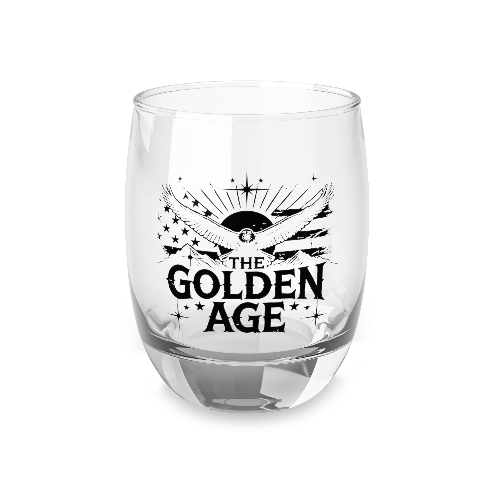 A clear whiskey glass with 'THE GOLDEN AGE' printed in black text on the side, featuring a sun and rays design.